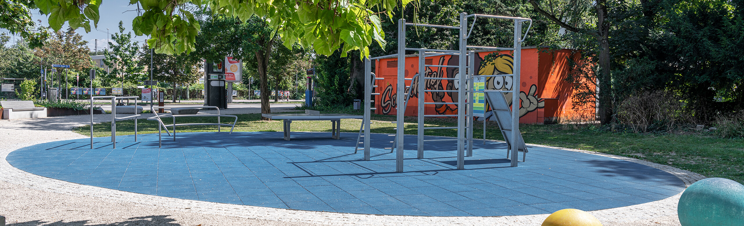 Blue safety tiles under climbing frame on a playground